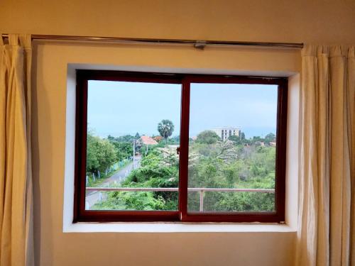 a window with a view of a street at Kep Villa Hill Guest House 1 in Kep