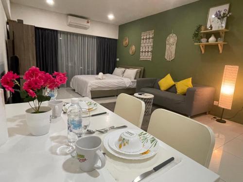 a living room with a table and a couch at Summer suites klcc by Peaceful Nest in Kuala Lumpur