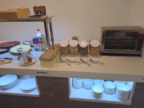 a counter with plates and utensils on a table at Hotel Merino in Pas de la Casa
