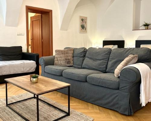uma sala de estar com um sofá azul e uma mesa de centro em Apartment Sophie - Old Town em Bratislava