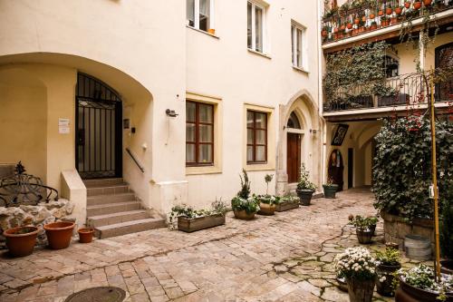 an alley with potted plants on the side of a building at Apartment Lea - Old Town in Bratislava