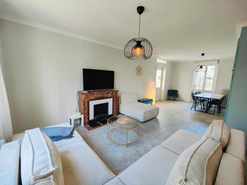 a living room with a couch and a fireplace at Self-checkin house - Private rooms to rent in a beautiful town house - Not a hotel - Shared facilities - Extra fee for sheets and towels - Private parking - Check your plateform inbox and follow check-in instructions - Chambres privées - Arrivée autonome in Saint-Romain-en-Gal