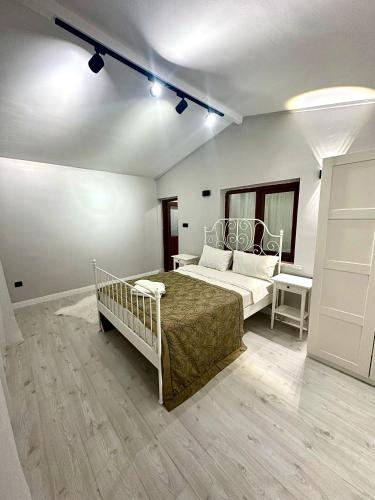 a white bedroom with a bed and a table at Tiny 1 in Istanbul
