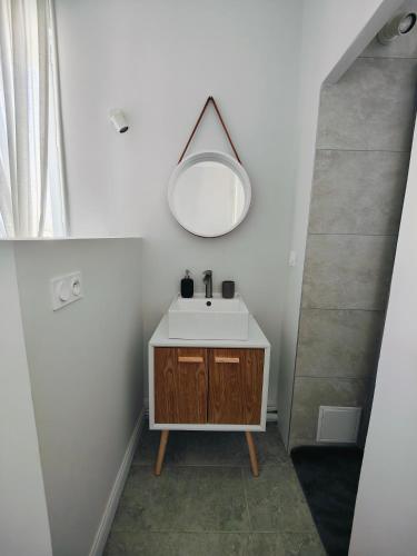 a bathroom with a sink and a mirror at Self-checkin house - Private rooms to rent in a beautiful town house - Not a hotel - Shared facilities - Extra fee for sheets and towels - Private parking - Check your plateform inbox and follow check-in instructions - Chambres privées - Arrivée autonome in Saint-Romain-en-Gal