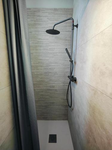 a shower with a shower head in a bathroom at Self-checkin house - Private rooms to rent in a beautiful town house - Not a hotel - Shared facilities - Extra fee for sheets and towels - Private parking - Check your plateform inbox and follow check-in instructions - Chambres privées - Arrivée autonome in Saint-Romain-en-Gal