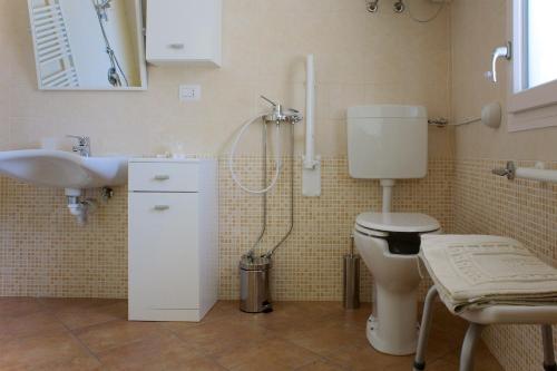 a bathroom with a toilet and a sink and a shower at La Via Del Volano in Codigoro