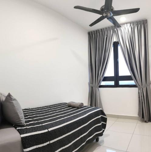 a bedroom with a black and white striped bed and a ceiling fan at MFA Putrajaya Homestay in Putrajaya