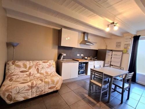 a kitchen with a couch and a table in a room at nice little cottage F2 class and 3* in Vars