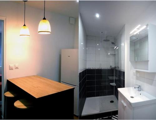 uma casa de banho com um lavatório, um chuveiro e uma mesa em L’Impérial 4- CentreVille- WIFI em Étampes