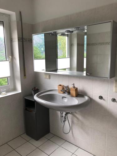 W łazience znajduje się umywalka i lustro. w obiekcie Ferienwohnung Zenzen w mieście Cochem