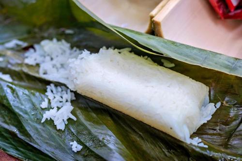 a pile of rice on top of a green leaf at Khaosok August Freedom Camp in Khao Sok