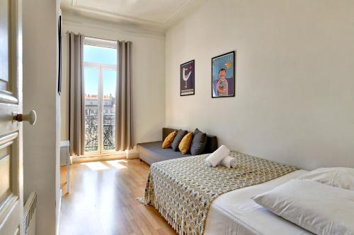 a bedroom with two beds and a couch in it at NOCNOC - Le Minot in Marseille