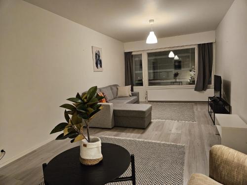 a living room with a couch and a table at Lapinkatu apartments in Rovaniemi