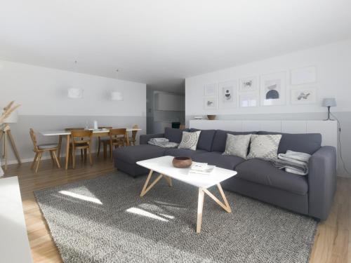 a living room with a blue couch and a table at Casa Bivio in Bivio
