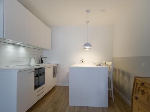 a kitchen with white cabinets and a white counter top at Casa Bivio in Bivio