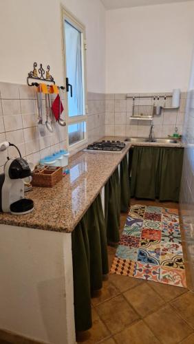 a kitchen with a counter top and a counter top at I Dammusi di Punta Karace in Tracino