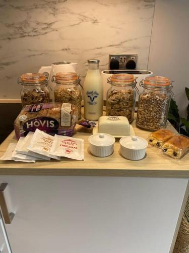 a shelf with jars of nuts and other food items at The Burrow Devon in Longdown