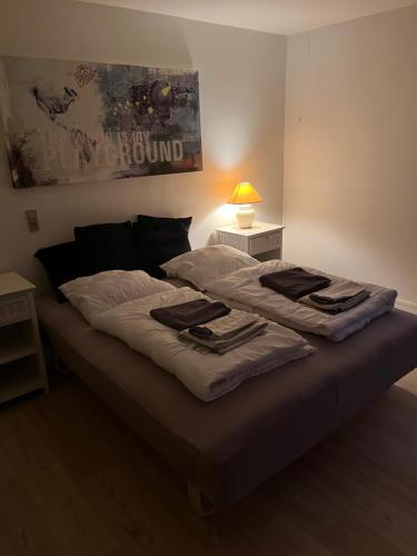 a bed with towels on it in a bedroom at Casa Home of Bricks - Downtown Holidays in Billund