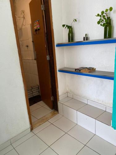 a bathroom with a shower with blue shelves at Surf café bar e hospedagem in Rio de Janeiro