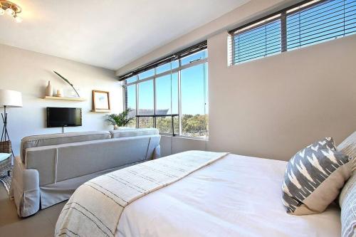 a bedroom with a bed and a large window at Morakani Studio 503 in Green Point. in Cape Town