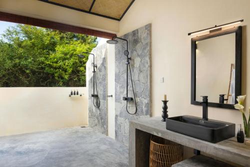 a bathroom with a sink and a shower at Aranya Trails Wilpattu in Pahala Maragahawewa