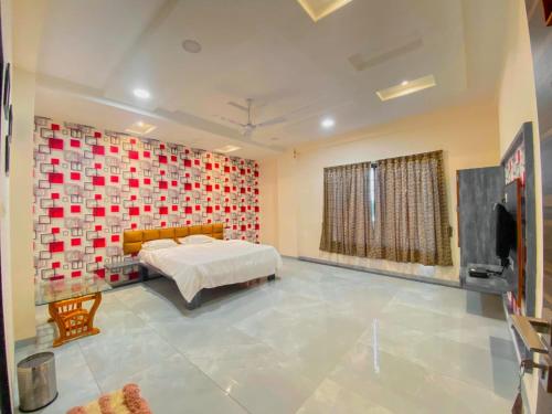 a bedroom with a bed and a wall of hearts at hotel sharda excutive 