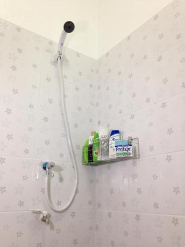 a shower head on a wall in a bathroom at SP House RoiEd in Roi Et