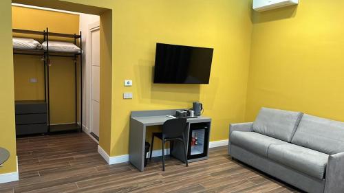 a living room with a couch and a flat screen tv at palazzo chinial in Torre del Greco