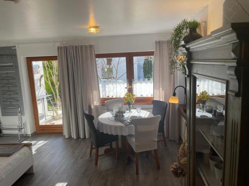 ein Esszimmer mit einem weißen Tisch und Stühlen in der Unterkunft Ferienwohnung Angelika in Kressbronn am Bodensee