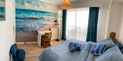 a bedroom with a bed and a painting of the ocean at 3 chambres avec vue dégagée au calme proche Paris et aéroport - parking in Le Bourget