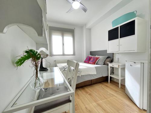 Ce petit appartement comprend un lit et une table en verre. dans l'établissement Habitación Atocha Mendez, à Madrid