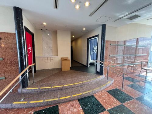 a hallway with a staircase in a building at Chateraise Hotel Nagano in Nagano