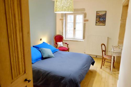 1 Schlafzimmer mit einem blauen Bett und 2 Stühlen in der Unterkunft Spacieuse maison de campagne/au cœur des vignobles in Chasselas