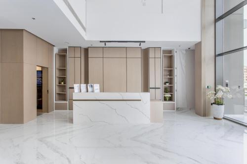a lobby with a white counter in a building at WeHost - Urban Oasis Modern Studio Retreat with City Views in Dubai