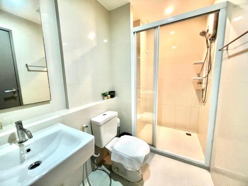 a bathroom with a toilet and a sink and a shower at Sea view Pattaya beach @The Base Central Pattaya in Pattaya Central