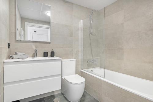 a bathroom with a toilet and a sink and a bath tub at Alexia 2 Calpe in Calpe