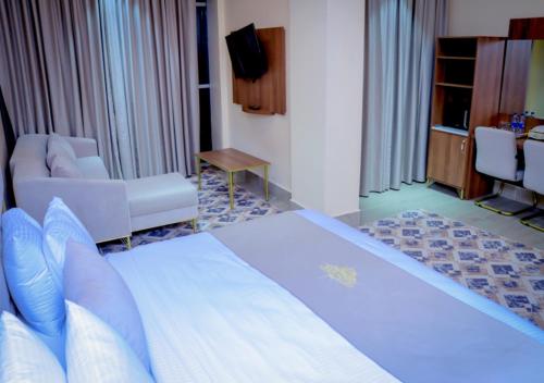a hotel room with a large bed and a living room at Jees Hotel in Hargeysa