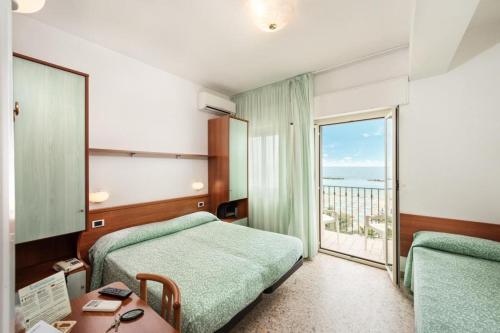 מיטה או מיטות בחדר ב-Hotel Poseidon e Nettuno