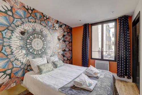 a bedroom with a flower mural on the wall at 127 Suite Moshé - Superbe Appartement à Paris. in Paris