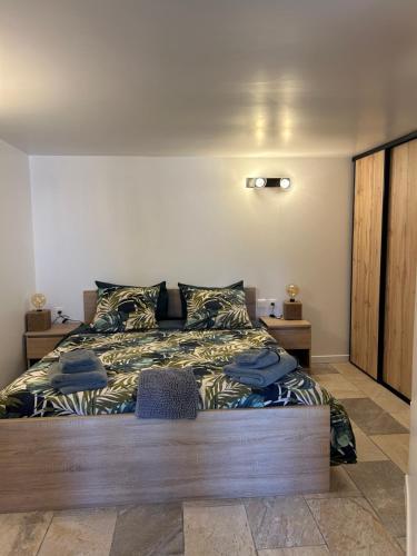 een slaapkamer met een groot bed met een houten frame bij Lake House St Pee Sur Nivelle in Saint-Pée-sur-Nivelle