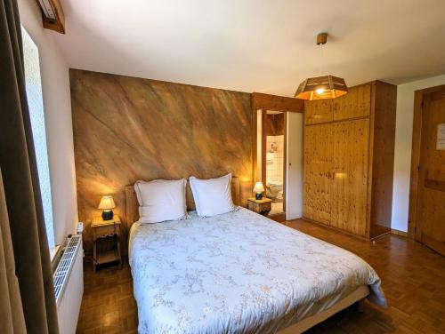 a bedroom with a large bed with two pillows at Chambre d'hôtes Kieffer Le Grand Bienfaisy in Remiremont