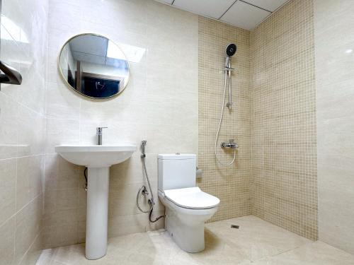 a bathroom with a toilet and a sink and a mirror at Lehbab Star Residence - Home Stay in Dubai