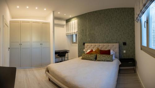 a bedroom with a large bed and a desk at Marina View 34 in Birgu