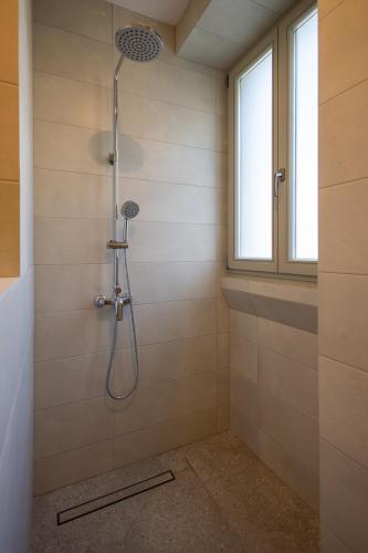 a shower stall in a bathroom with a window at Marina View 34 in Birgu