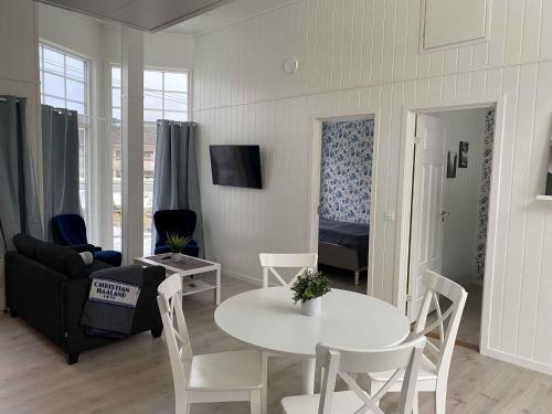 a living room with a table and a couch at Rosendal Apartments Motellet in Rosendal