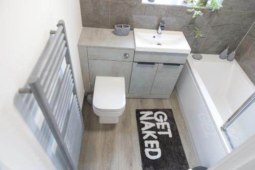 a bathroom with a toilet and a sink and a bath tub at Jalebo in Cleethorpes