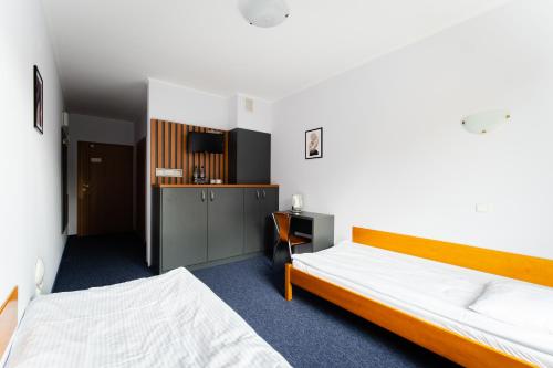 ein Hotelzimmer mit 2 Betten und einer Küche in der Unterkunft Karpackie Pokoje in Krosno