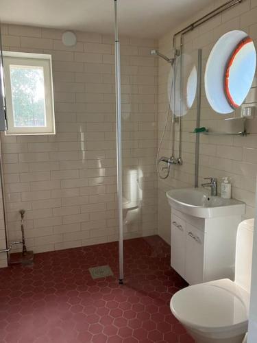 a bathroom with a shower and a toilet and a sink at Garden house near centre in Tampere