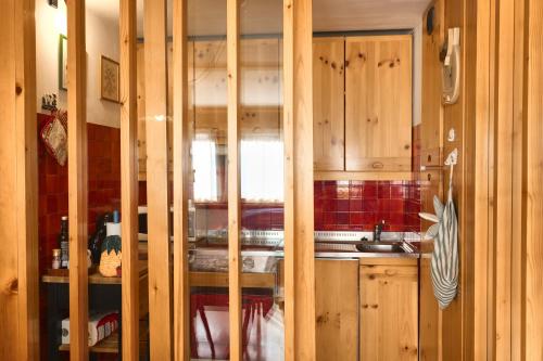 a kitchen with wooden cabinets and a sink at Villa Antermont in Canazei