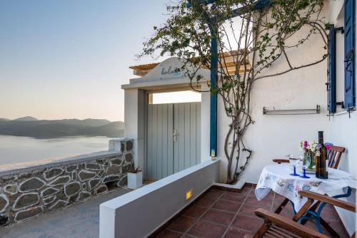 a room with a table and a view of the ocean at Melisses Sea View Studio in Plaka Milou